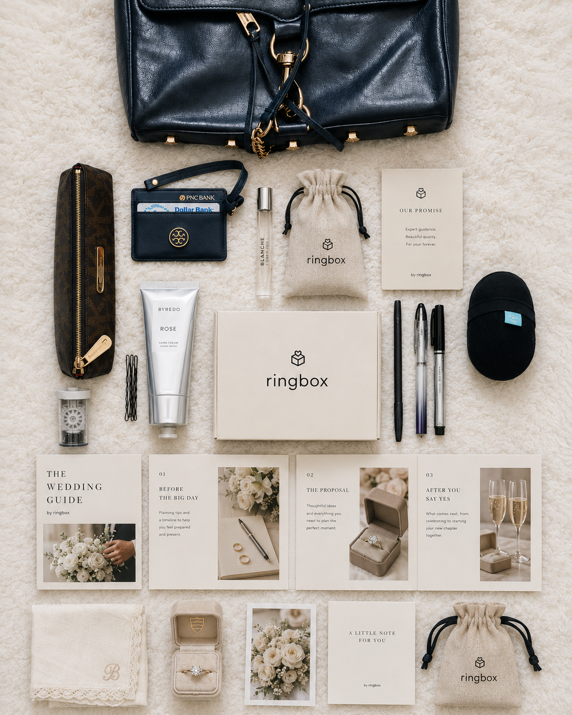 An example RingBox spread — Wedding Guide, hand cream, ring keepsake, note card, ribbon-tied pouches, and more